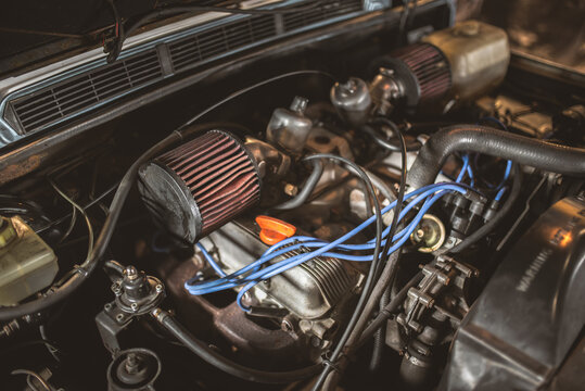 Close-up view of a vintage car engine with performance air filters