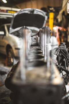 Close-up view of a car engine cylinder block in a repair shop setting