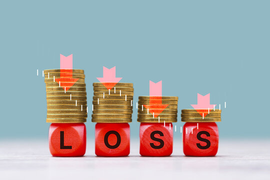 Decreasing stacks of golden coins standing on red wooden cubes spelling the word LOSS with large red downward arrows above each stack. Concept financial loss, decreasing profit and business decline.