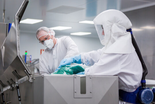 Food technicians testing candy batch in hygienic laboratory