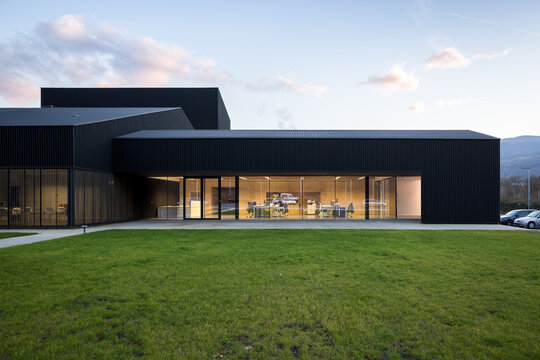 Modern candy factory with glass facade and sleek dark exterior