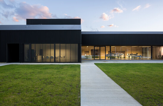 Modern candy factory building with glass facade at dusk