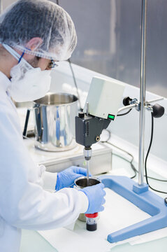 Technician testing candy mixture in factory quality lab