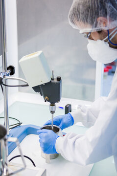 Candy laboratory technician mixing ingredients in factory lab