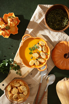 Autumn pumpkin soup with croutons and herbs