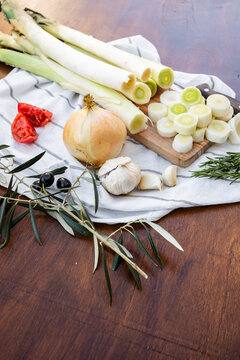 Fresh leeks and aromatics prepared for rustic cooking
