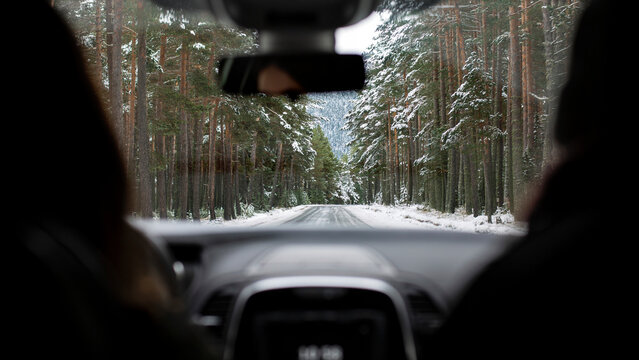 Winter drive through a snowy forest landscape