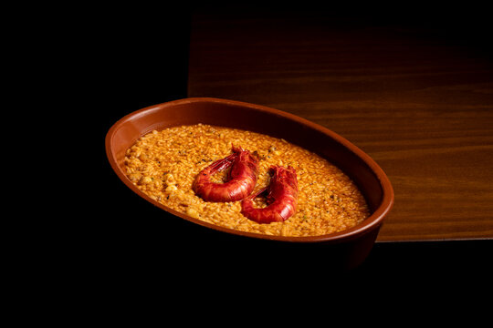 Spanish rice dish with prawns served in Traditional clay