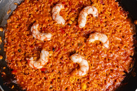 Spanish seafood rice with shrimp cooked in traditional paella pan