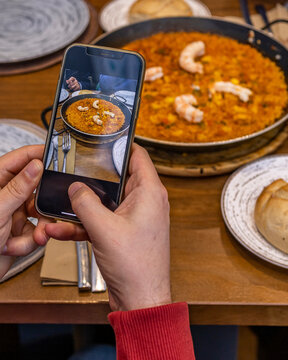 Taking a photo of Spanish rice dish in a paella pan