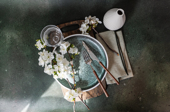 Minimal interior table setting with cherry blossom branch