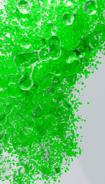 Bright green bubbles cascade on white backdrop