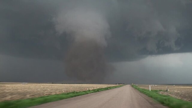 A large dusty tornado in Nebraska. Storm chaser footage shot from a moving car.