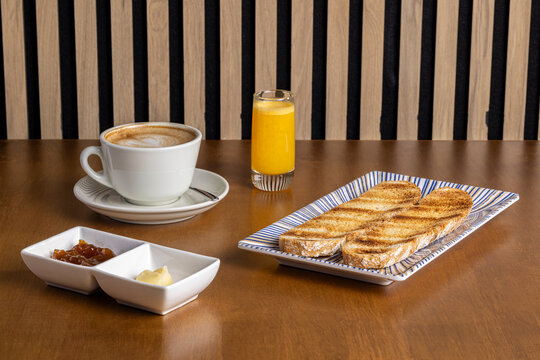 Breakfast toast with coffee and juice on cafe table
