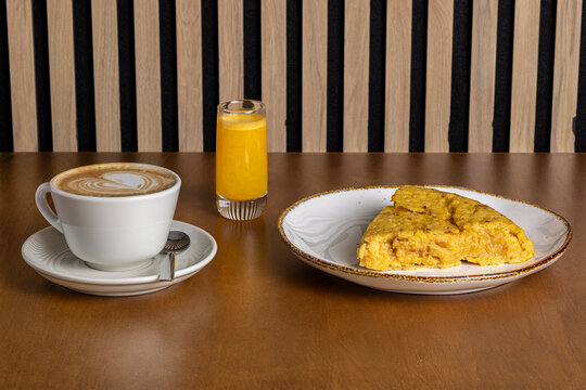 Morning breakfast with omelet, coffee latte, and juice