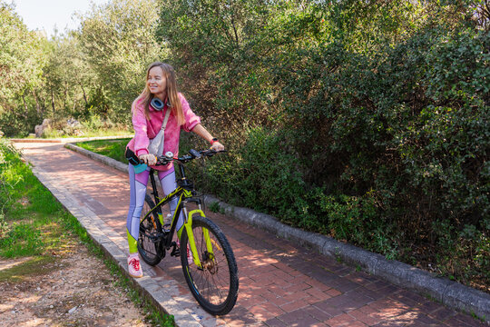 Woman enjoying a bike ride in a sunny park