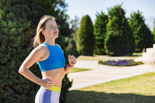 Woman jogging in park on a sunny day