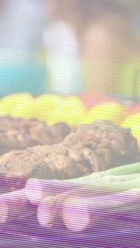 Vertical video: Grill heat igniting asparagus, peppers and kebabs, searing and browning for serving