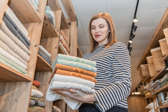 Woman shopping for textiles in a cozy store setting