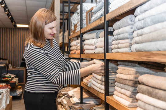 Woman shopping for textiles in a cozy store setting