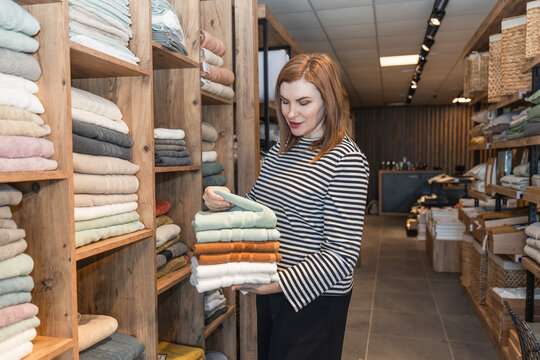 Woman shopping in a textile store aisle