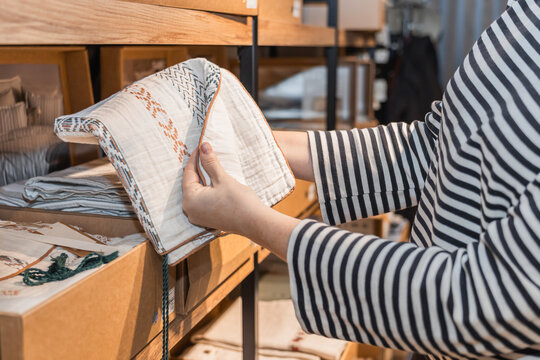 Woman shopping for textiles in a store setting