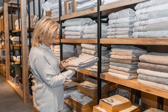 Woman browsing textiles in a cozy store setting
