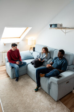 Friends relaxing and chatting on a cozy sofa