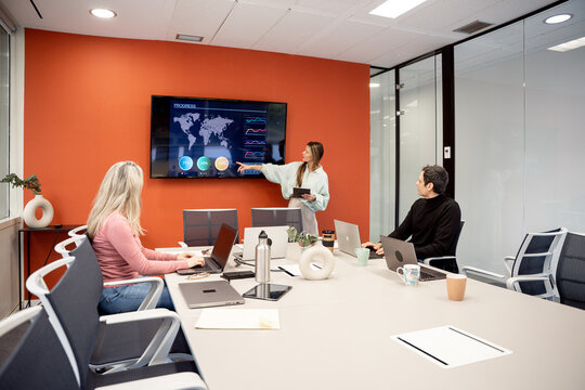 Coworking team meeting with data presentation in office