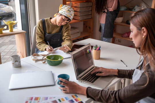 Pottery workshop team planning ceramic collection at studio