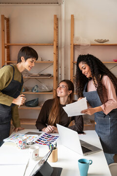 Pottery workshop team reviewing glaze colors and design plan