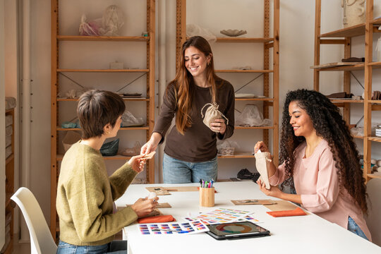 Pottery workshop class with women shaping clay at studio