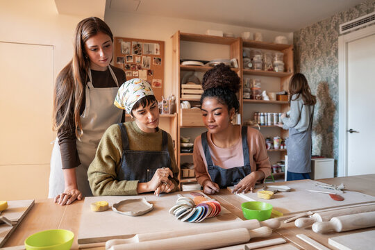 Pottery workshop class shaping clay and learning ceramic craft