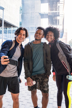 Young friends taking a selfie outdoors with backpack