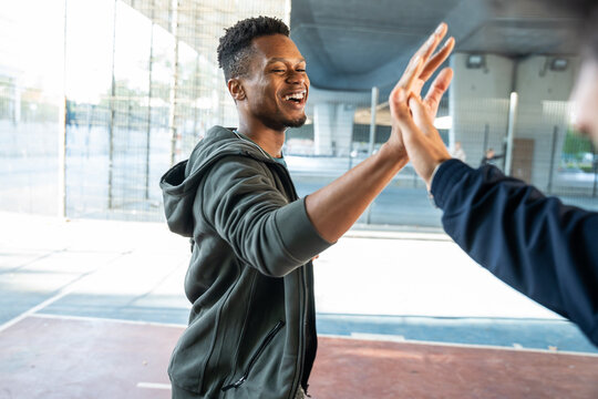 Man giving high five after outdoor sport practice session
