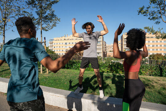 Outdoor fitness class with friends doing jumping jack
