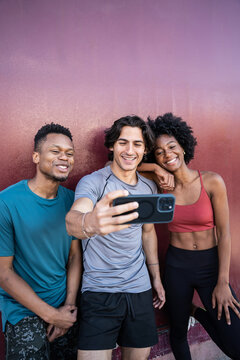Young friends taking a selfie after outdoor workout session