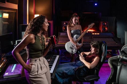 Women relaxing in a recording studio during music session