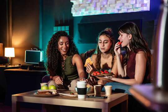 Women taking a break in recording studio with snack