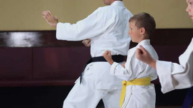 Karate athletes perform a moving punch