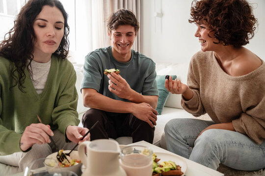 Friends sharing healthy snacks and laughter at home
