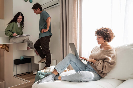 Remote work at home while roommates plan chores and notes