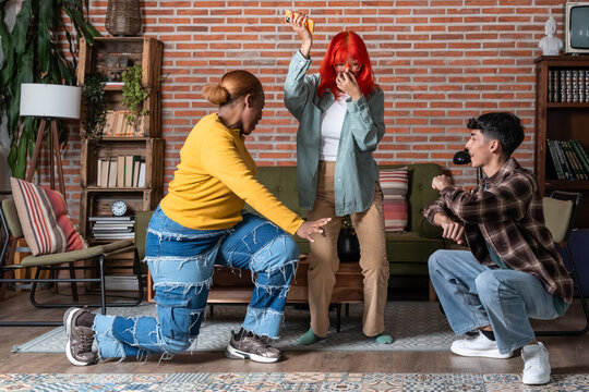 Friends playing party game in cozy living room at home