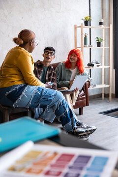 Casual design meeting with laptop in modern studio lounge