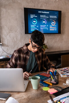 Remote worker planning OKR goals at desk with laptop