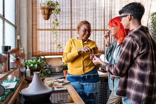 Friends sharing a snack in a cozy sunlit kitchen
