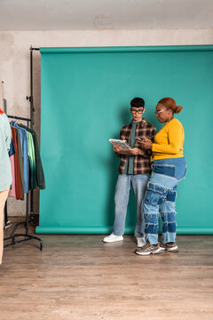 Fashion team review color swatch in studio with backdrop