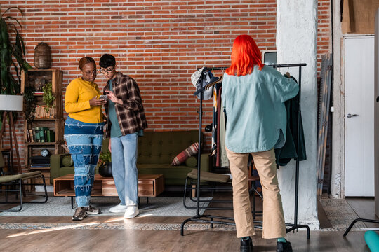 Multiethnic fashion team selecting outfits for production