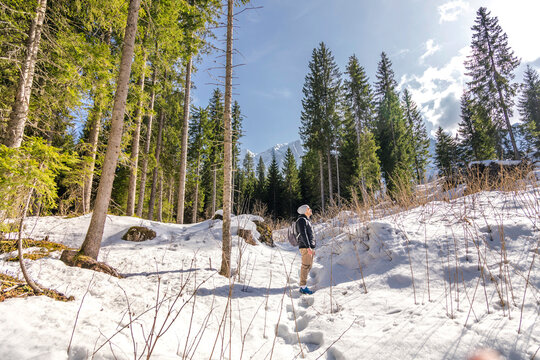 Winter hike at Carezza Lake forest in Alto Adige, Italy
