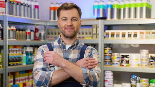 Confident male worker smiling in hardware store